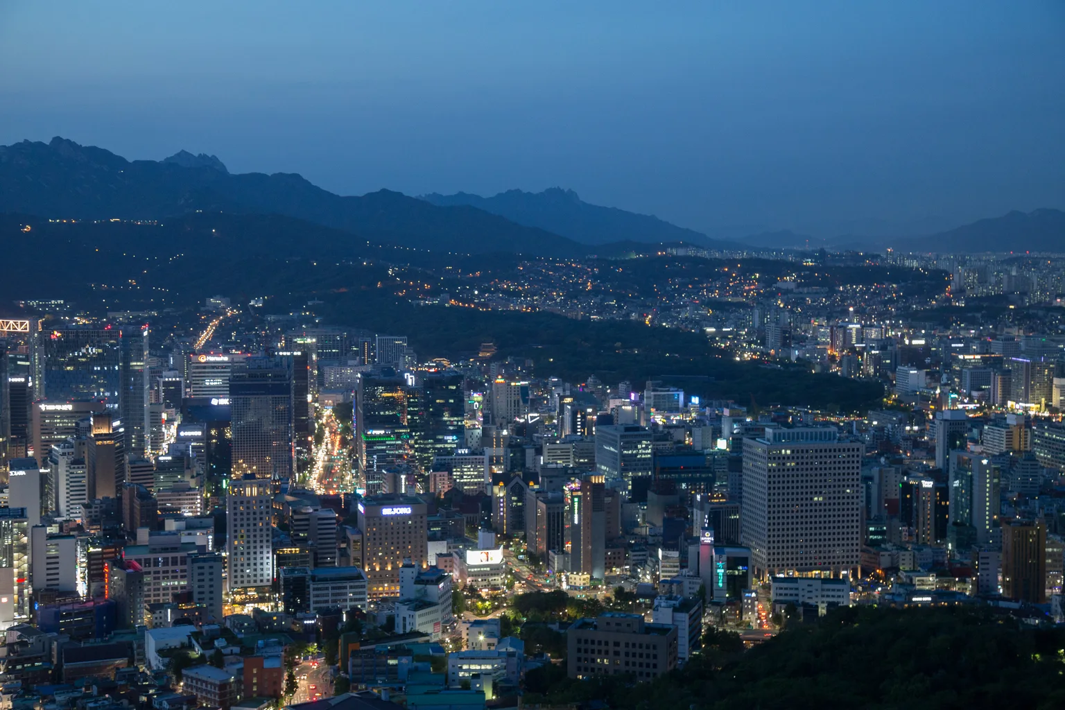 Seoul skyline and surrounding hills in the evening